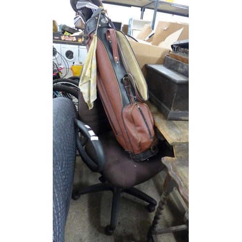 2336 - Brown office chair with set of golf irons & woods in bag