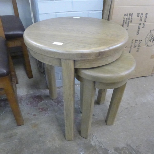 1549 - A circular oak nest of two tables  *This lot is subject to VAT