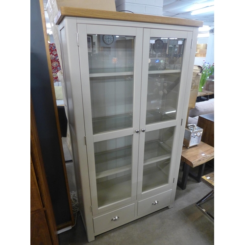 1569 - A stone glass two door, two drawer display cabinet