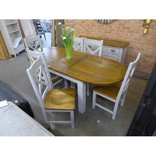 1596 - A rustic painted pine extending dining table and six cross back dining chairs