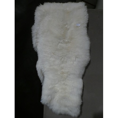 3999 - A cream faux fur rug * This lot is subject to VAT