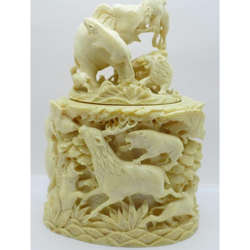 683 - A cast resin faux ivory carving of lions and tigers hunting animals, a/f