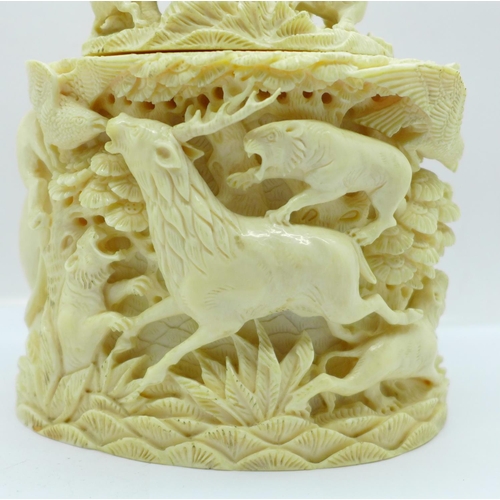 683 - A cast resin faux ivory carving of lions and tigers hunting animals, a/f