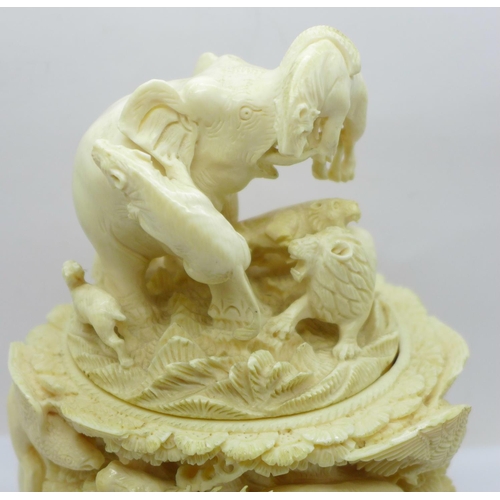 683 - A cast resin faux ivory carving of lions and tigers hunting animals, a/f