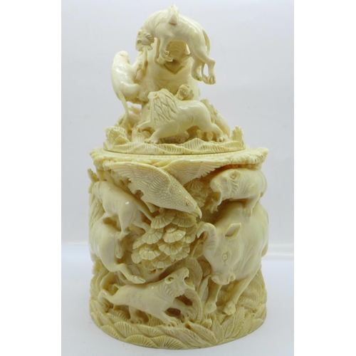 683 - A cast resin faux ivory carving of lions and tigers hunting animals, a/f