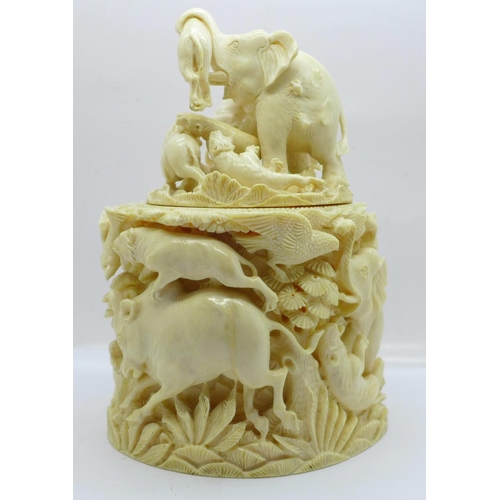 683 - A cast resin faux ivory carving of lions and tigers hunting animals, a/f