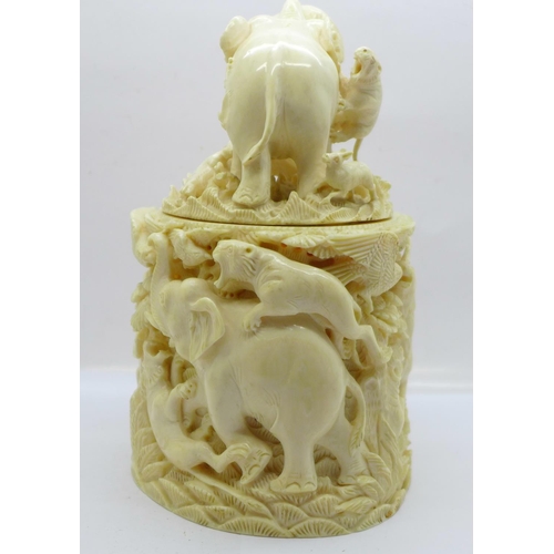 683 - A cast resin faux ivory carving of lions and tigers hunting animals, a/f