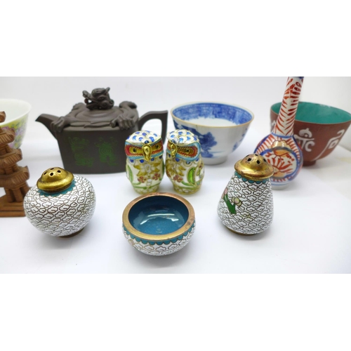 704 - Oriental items, a cloisonne salt and pepper pot, two cloisonne owls, tea bowls, a carving, teapot, m... 