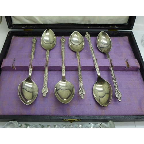 705 - Nine glass knife rests, a set of plated Apostle spoons and two glass dressing table containers with ... 