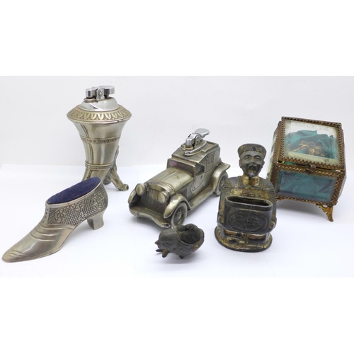 731 - Two novelty table lighters, two pin cushions, (chick a/f), a match holder and a gilt metal and bevel... 