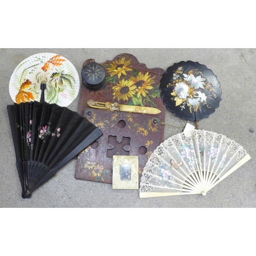 747 - A papier-mache lacquered hand fan inlaid with mother of pearl, three fans, circular box, Art Nouveau... 