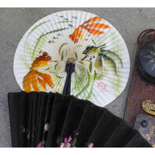 747 - A papier-mache lacquered hand fan inlaid with mother of pearl, three fans, circular box, Art Nouveau... 