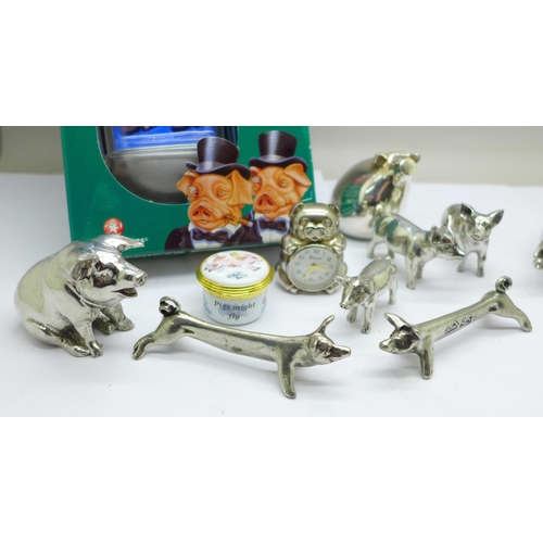 778 - A silver plated pig figure, pig knife rests, an enamel pill box, a pig game and other pig figures