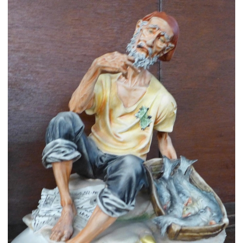 1278D - A Capodimonte figure of a gentleman with fish, a/f, (missing two toes on one foot) and one other con... 