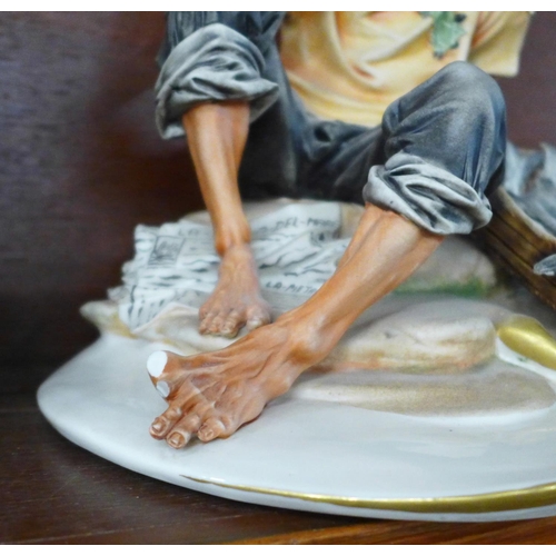 1278D - A Capodimonte figure of a gentleman with fish, a/f, (missing two toes on one foot) and one other con... 