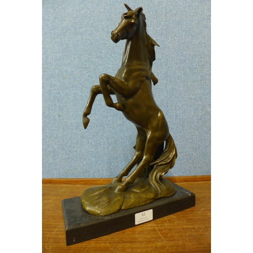 40 - A bronze figure of a rearing stallion, on black marble plinth, 41cm