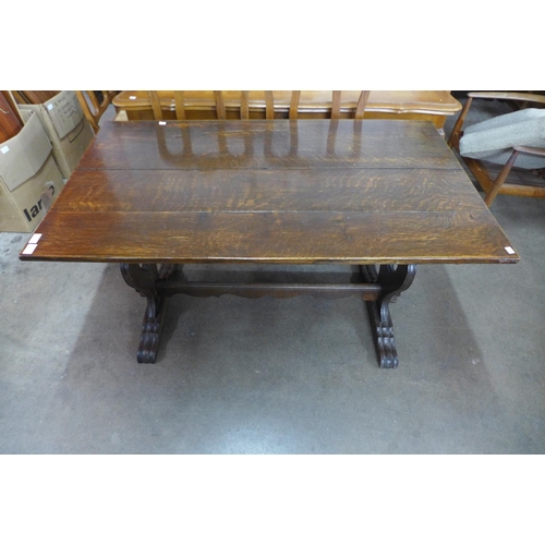 297 - A French carved oak refectory table, 74cms h, 133cms l,  78cms w