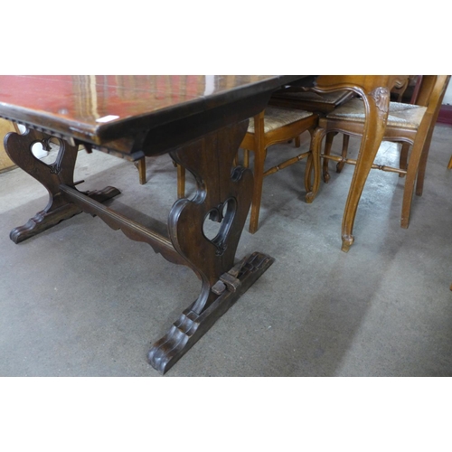 297 - A French carved oak refectory table, 74cms h, 133cms l,  78cms w