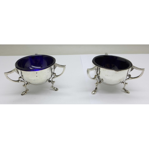 1001 - A pair of Edwardian hammered silver Arts and Crafts salt cellars, London 1909, makers mark worn, wit... 