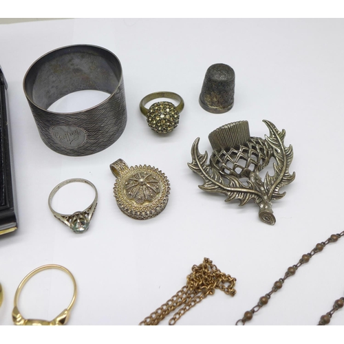 1035 - A silver brooch, costume jewellery, a silver napkin ring and a silver thimble