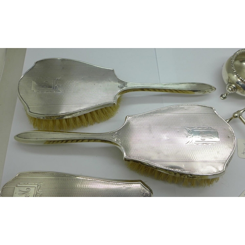 1042 - A silver salt, pepper, knife rest, napkin ring and two spoons, total weight 175g, and four silver ba... 