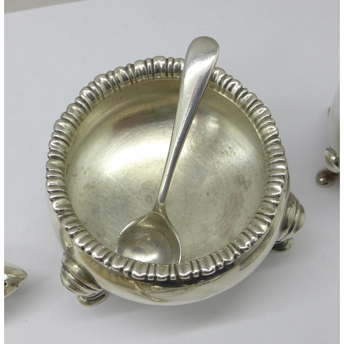 1042 - A silver salt, pepper, knife rest, napkin ring and two spoons, total weight 175g, and four silver ba... 