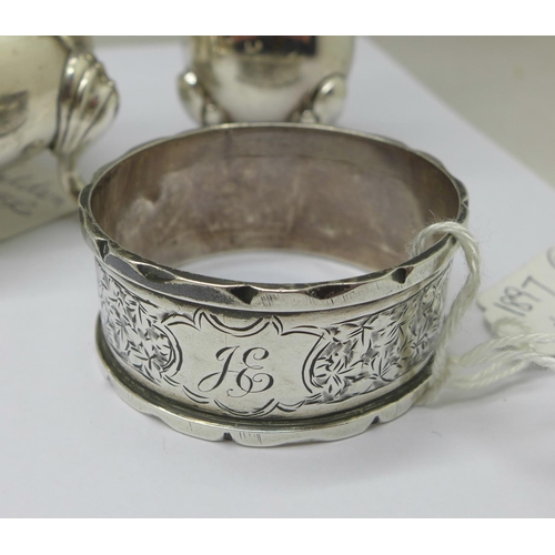 1042 - A silver salt, pepper, knife rest, napkin ring and two spoons, total weight 175g, and four silver ba... 