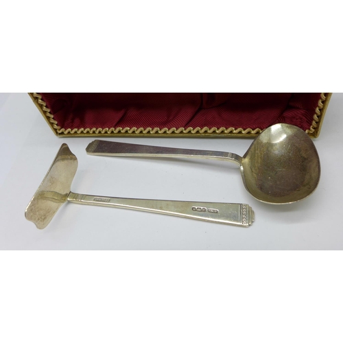 1043 - Two silver napkin rings, a silver feeding spoon and pusher and a silver egg cup and spoon, 110g, den... 