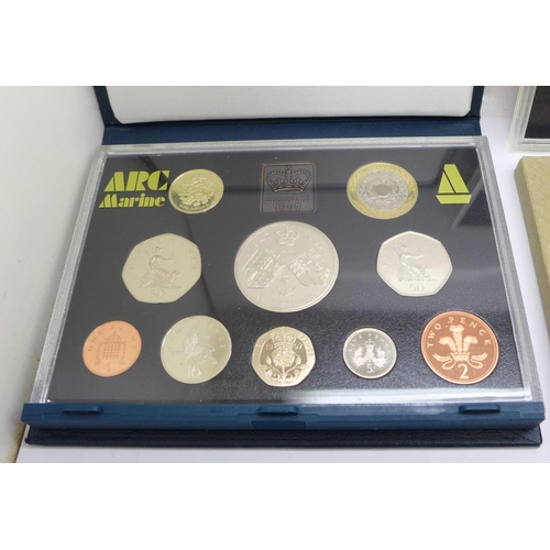 1052 - Three Royal Mint proof sets:- 1976, 1994 including the Special Bank of England £2 and D-Day 50p coin... 