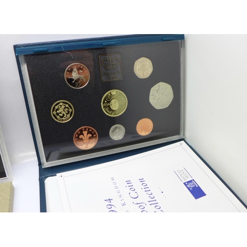 1052 - Three Royal Mint proof sets:- 1976, 1994 including the Special Bank of England £2 and D-Day 50p coin... 