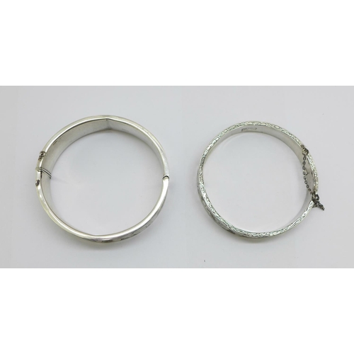 1084 - Two silver bangles, 38g, both dented