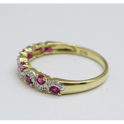 1150 - A 9ct gold, ruby and diamond half eternity ring, 1.5g, N