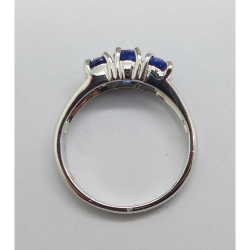 1154 - A 9ct white gold and three stone tanzanite ring, 3.2g, N