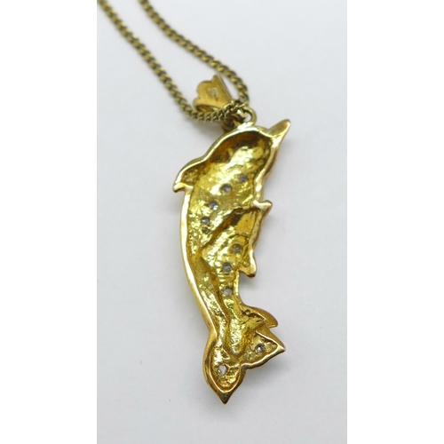 1159 - A 9ct gold and diamond studded dolphin pendant on a silver gilt chain, pendant 1.4g