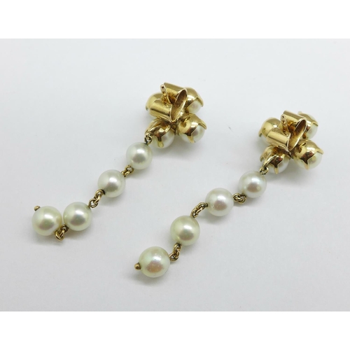 1162 - A pair of 14k gold and pearl drop earrings, the butterflies marked 14k