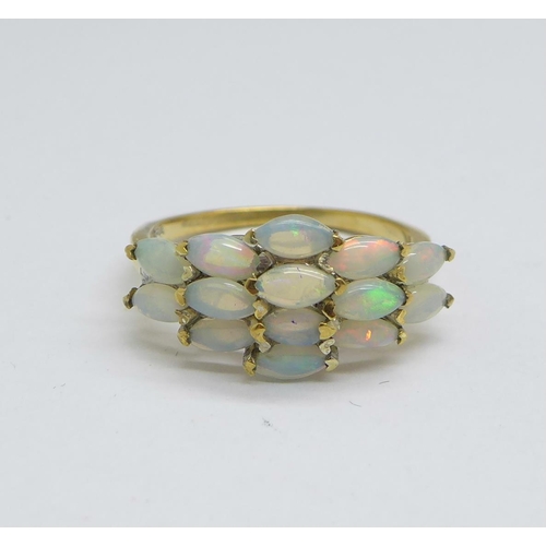 1167 - A silver gilt ring set with fourteen opals, M