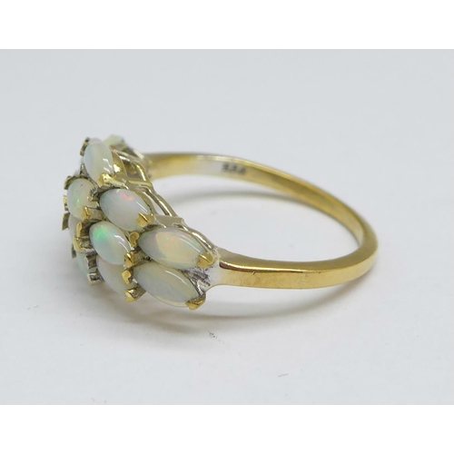 1167 - A silver gilt ring set with fourteen opals, M