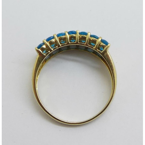 1170 - A 9ct gold ring set with twenty-one blue stones, 2.3g, O