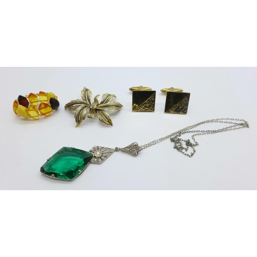 1174 - A silver gilt brooch, an Art Deco necklace, an amber ring and a pair of gilt cufflinks