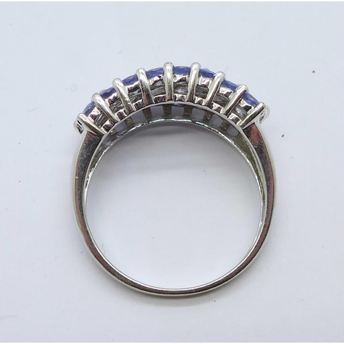 1188 - A 9ct white gold ring set with violet coloured stones, 4.1g, Q