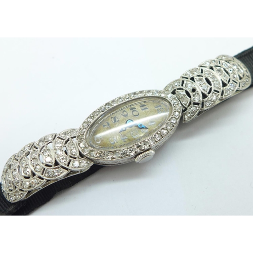 1197 - A lady's Art Deco diamond set cocktail wristwatch, the case marked 'Platine', 18/19mm wide, lacking ... 