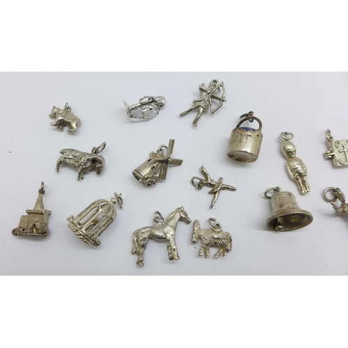 1202 - Fifteen silver charms, 46g