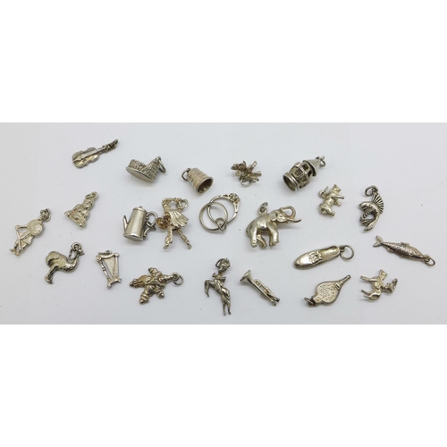 1204 - Twenty-two silver charms, 46g