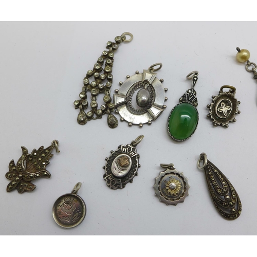 1217 - A collection of white metal pendants and charms including Victorian, four marked silver