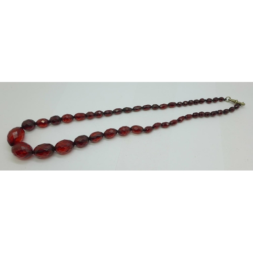 1229 - A string of faceted sherry amber coloured beads, 60cm