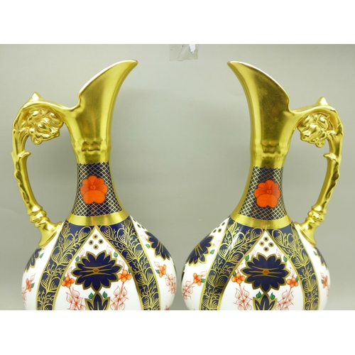 680 - A pair of Royal Crown Derby 1128 pattern ewers, 25.5cm, (one with hairline crack on the handle)