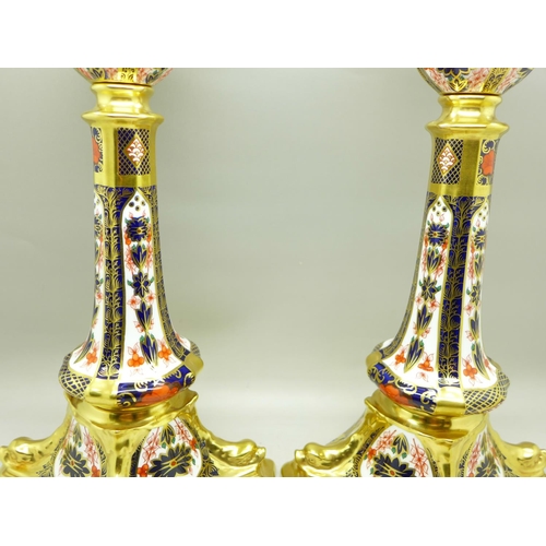 682 - A pair of Royal Crown Derby 1128 pattern candlesticks, 27cm