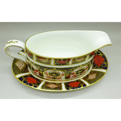 685 - A Royal Crown Derby 1128 pattern gravy boat with stand