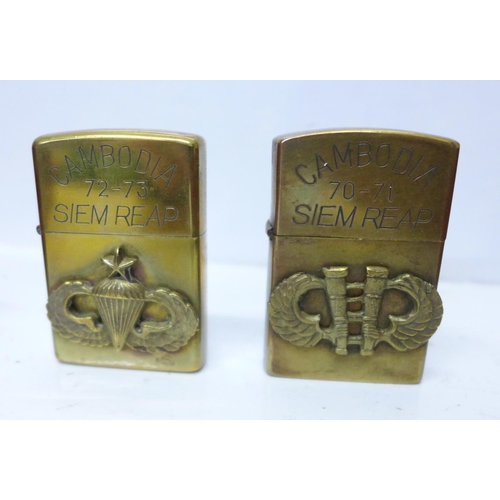 733 - Two cased sets of Zippo lighters, eight brass and twenty mixed, all bearing mottos or motifs