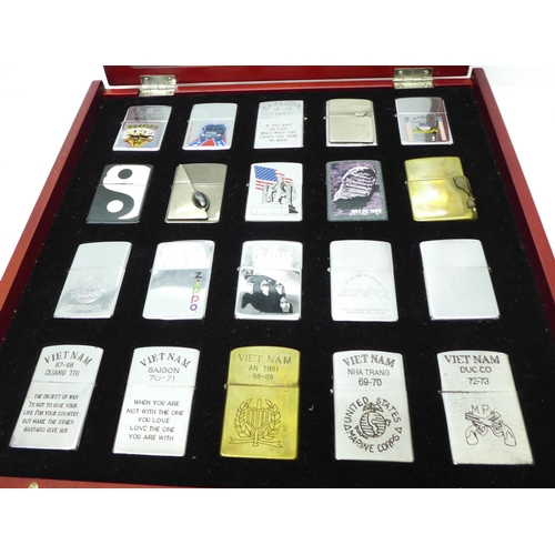 733 - Two cased sets of Zippo lighters, eight brass and twenty mixed, all bearing mottos or motifs